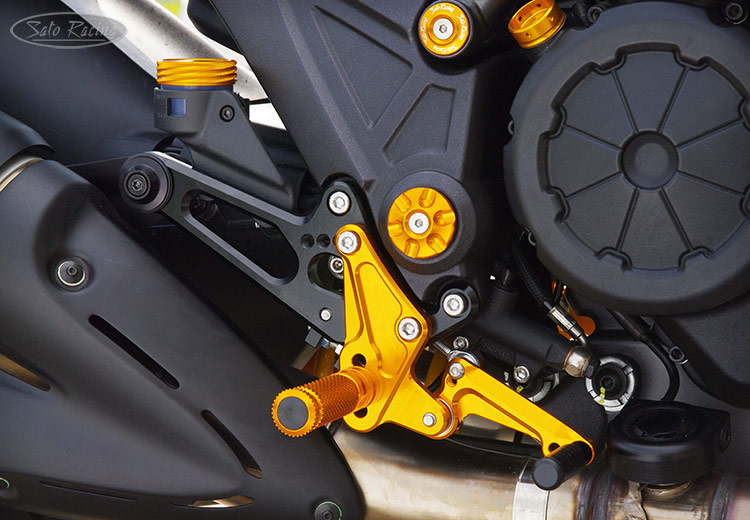 SATO RACING Rear Sets [R]-side on a Ducati Diavel. SATO RACING Brake Fluid Reservoir Cap and Oil Filler Cap also shown.