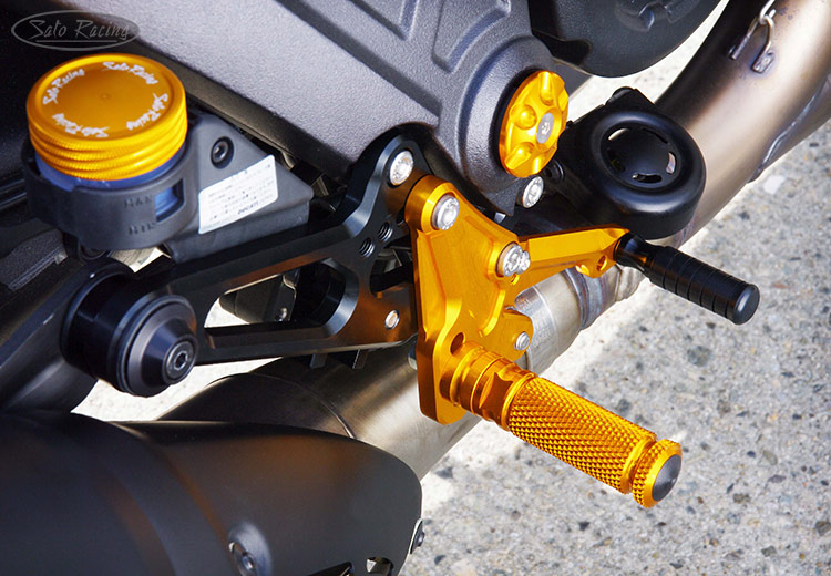 SATO RACING Rear Sets [R]-side on a Ducati Diavel. Sato Fluid Reservoir Cap also shown.